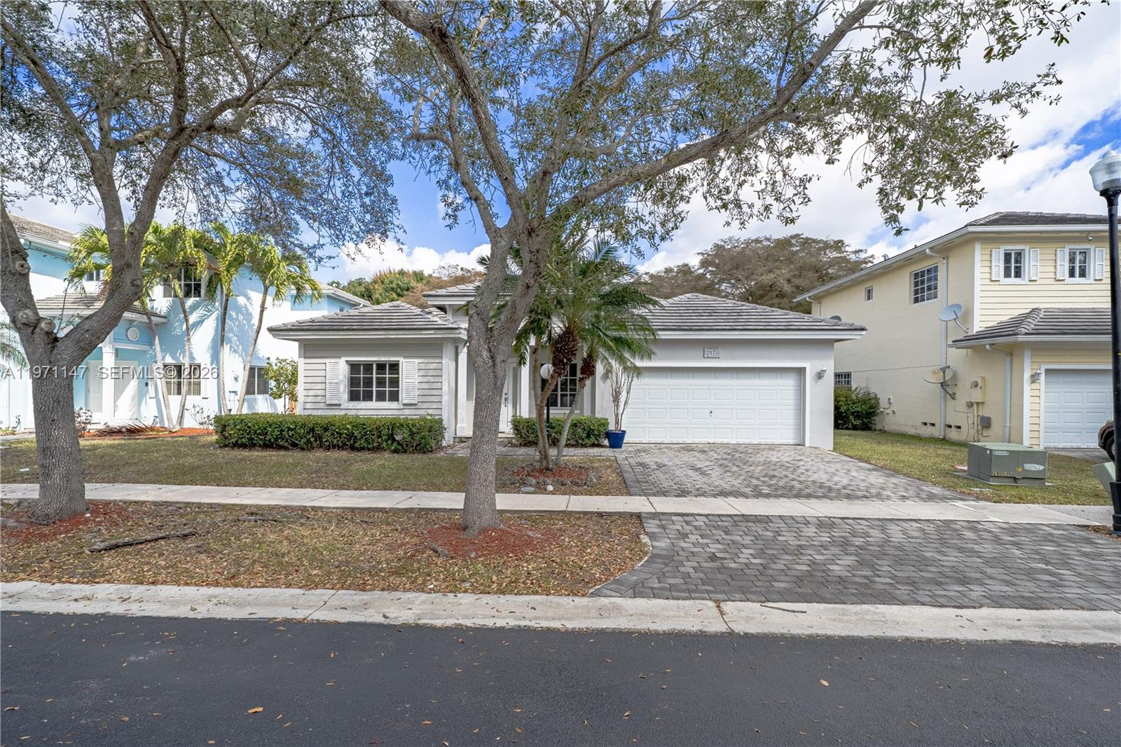 2875 Northeast 4th Street Homestead, FL 33033 - Photo 2 of 53 a front view of a house with a yard and garage