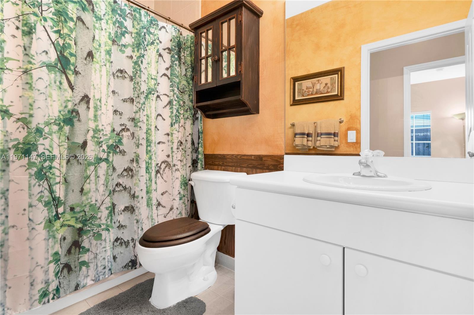 2875 Northeast 4th Street Homestead, FL 33033 - Photo 33 of 53 a bathroom with a sink and mirror with toilet