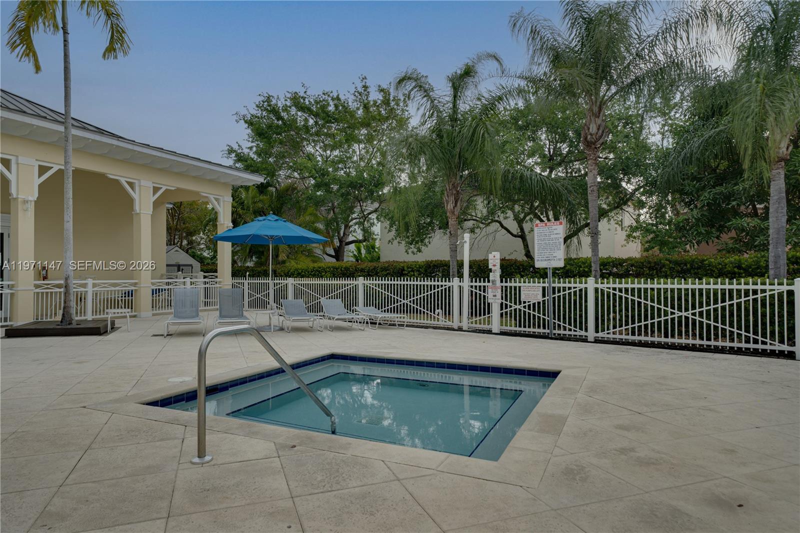 2875 Northeast 4th Street Homestead, FL 33033 - Photo 40 of 53 a view of a swimming pool with a table and chairs under an umbrella