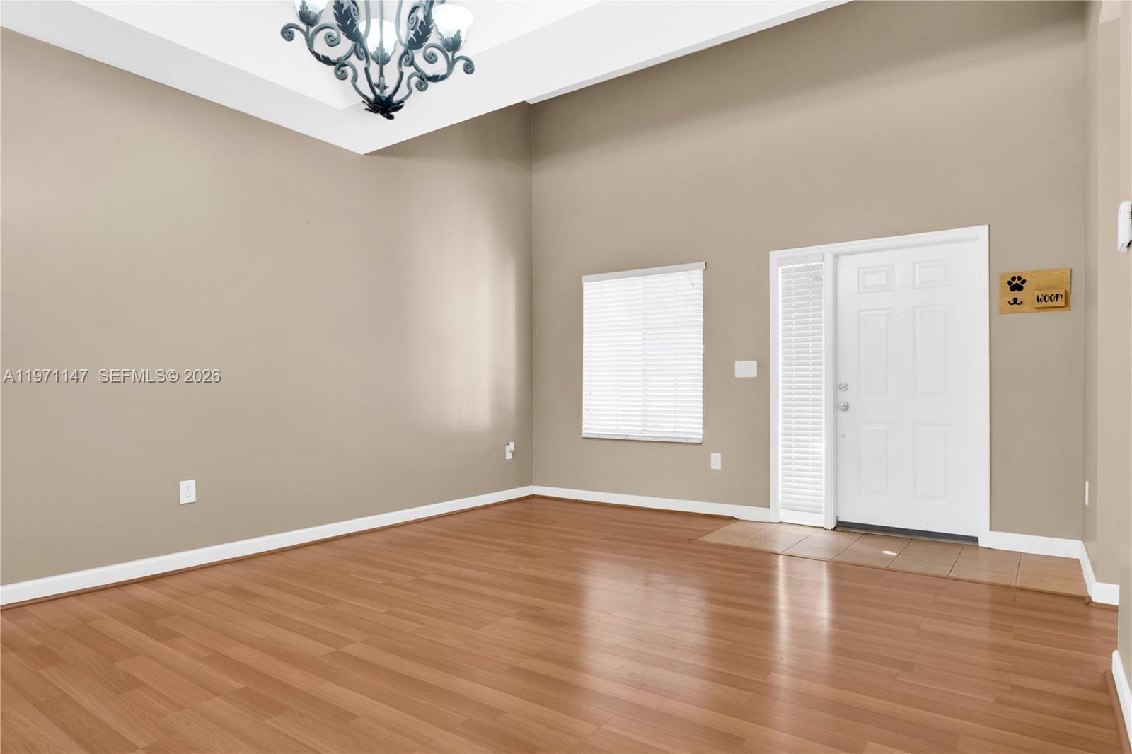 2875 Northeast 4th Street Homestead, FL 33033 - Photo 4 of 53 a view of an empty room with wooden floor and a window