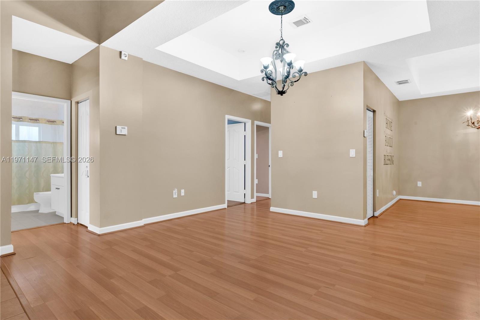 2875 Northeast 4th Street Homestead, FL 33033 - Photo 6 of 53 a view of an empty room with wooden floor and a chandelier
