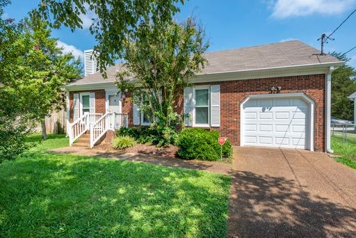 308 Cedarcliff Road Antioch, TN 37013 - Photo 2 of 20 a front view of a house with a yard and garage