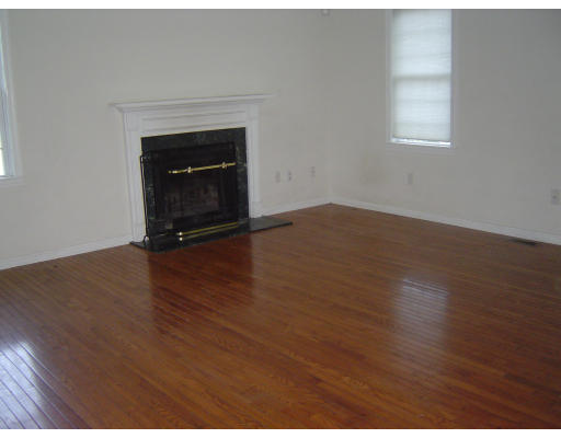 7 Leland Hill Road Sutton, MA 01590 - Photo 2 of 7 a view of empty room with wooden floor and fireplace