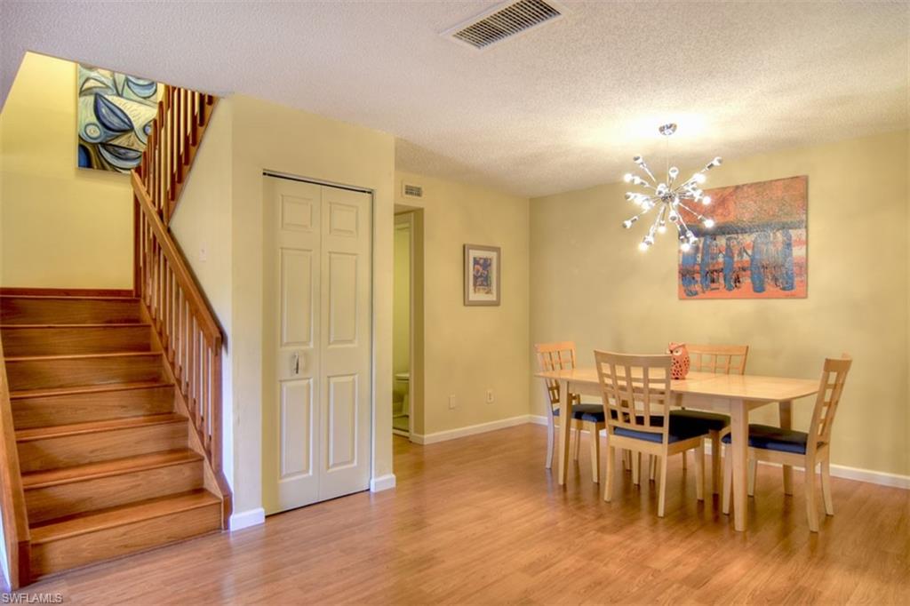 1468 Park Shore Circle, Unit 4 Fort Myers, FL 33901 - Photo 11 of 32 a view of a dining room with furniture and wooden floor