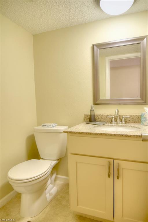 1468 Park Shore Circle, Unit 4 Fort Myers, FL 33901 - Photo 14 of 32 a bathroom with a toilet sink and mirror