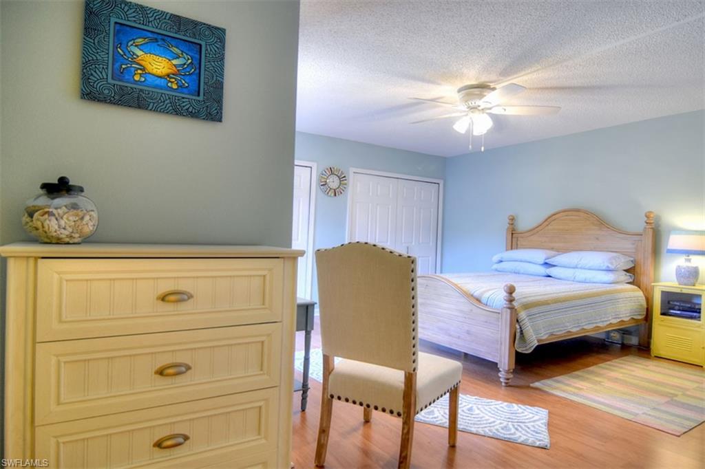 1468 Park Shore Circle, Unit 4 Fort Myers, FL 33901 - Photo 15 of 32 a living room with furniture and a chandelier