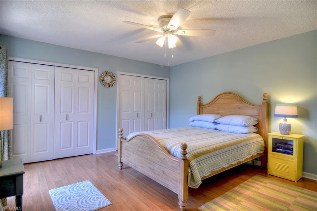 1468 Park Shore Circle, Unit 4 Fort Myers, FL 33901 - Photo 16 of 32 a bedroom with a bed and a chandelier