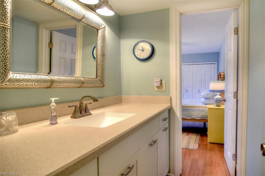 1468 Park Shore Circle, Unit 4 Fort Myers, FL 33901 - Photo 20 of 32 a en suite bathroom with a granite countertop sink and a mirror