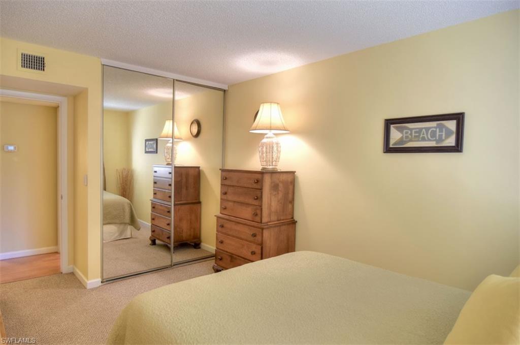 1468 Park Shore Circle, Unit 4 Fort Myers, FL 33901 - Photo 24 of 32 a bedroom with a bed and a cabinets