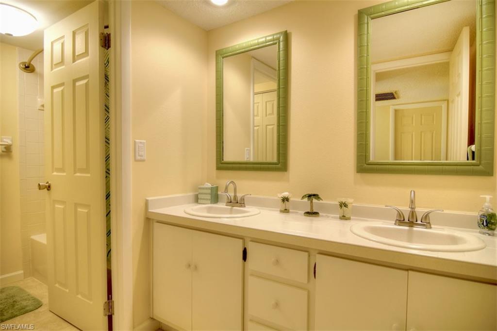 1468 Park Shore Circle, Unit 4 Fort Myers, FL 33901 - Photo 25 of 32 a bathroom with a double vanity sink mirror and