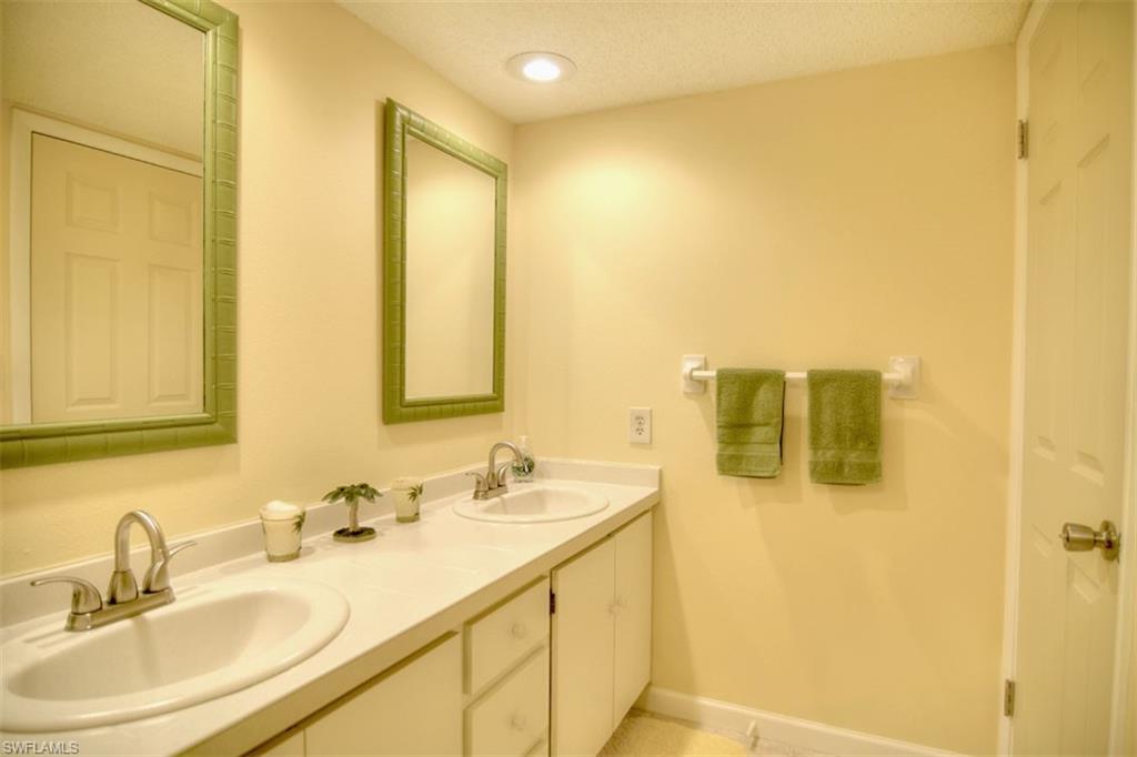 1468 Park Shore Circle, Unit 4 Fort Myers, FL 33901 - Photo 26 of 32 a bathroom with a sink and a mirror