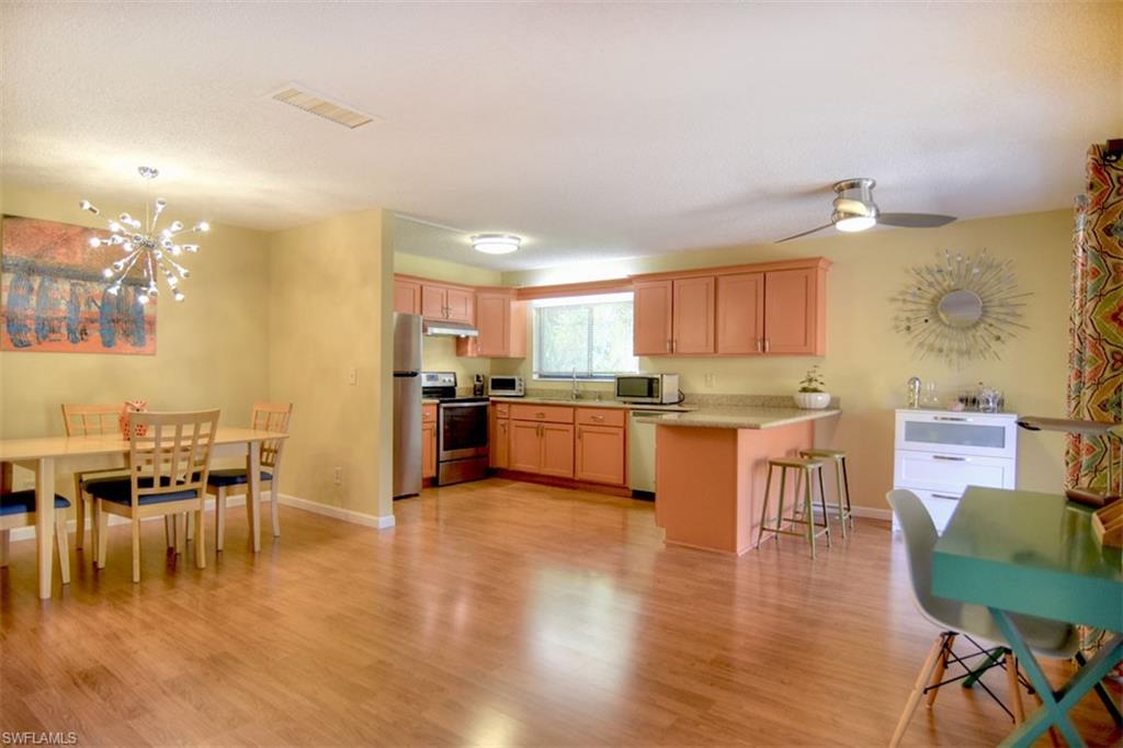 1468 Park Shore Circle, Unit 4 Fort Myers, FL 33901 - Photo 6 of 32 a kitchen with a table chairs refrigerator and cabinets