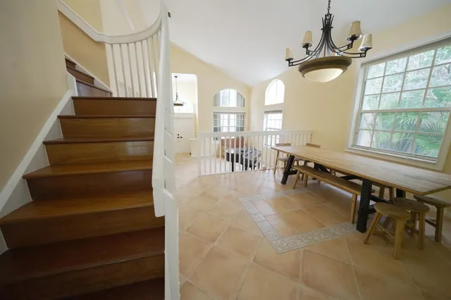 a room with lots of wooden furniture and windows