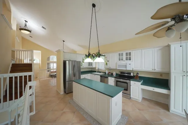 a kitchen with kitchen island granite countertop a stove and a center island