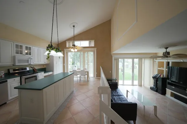a living room with furniture a flat screen tv and a large window