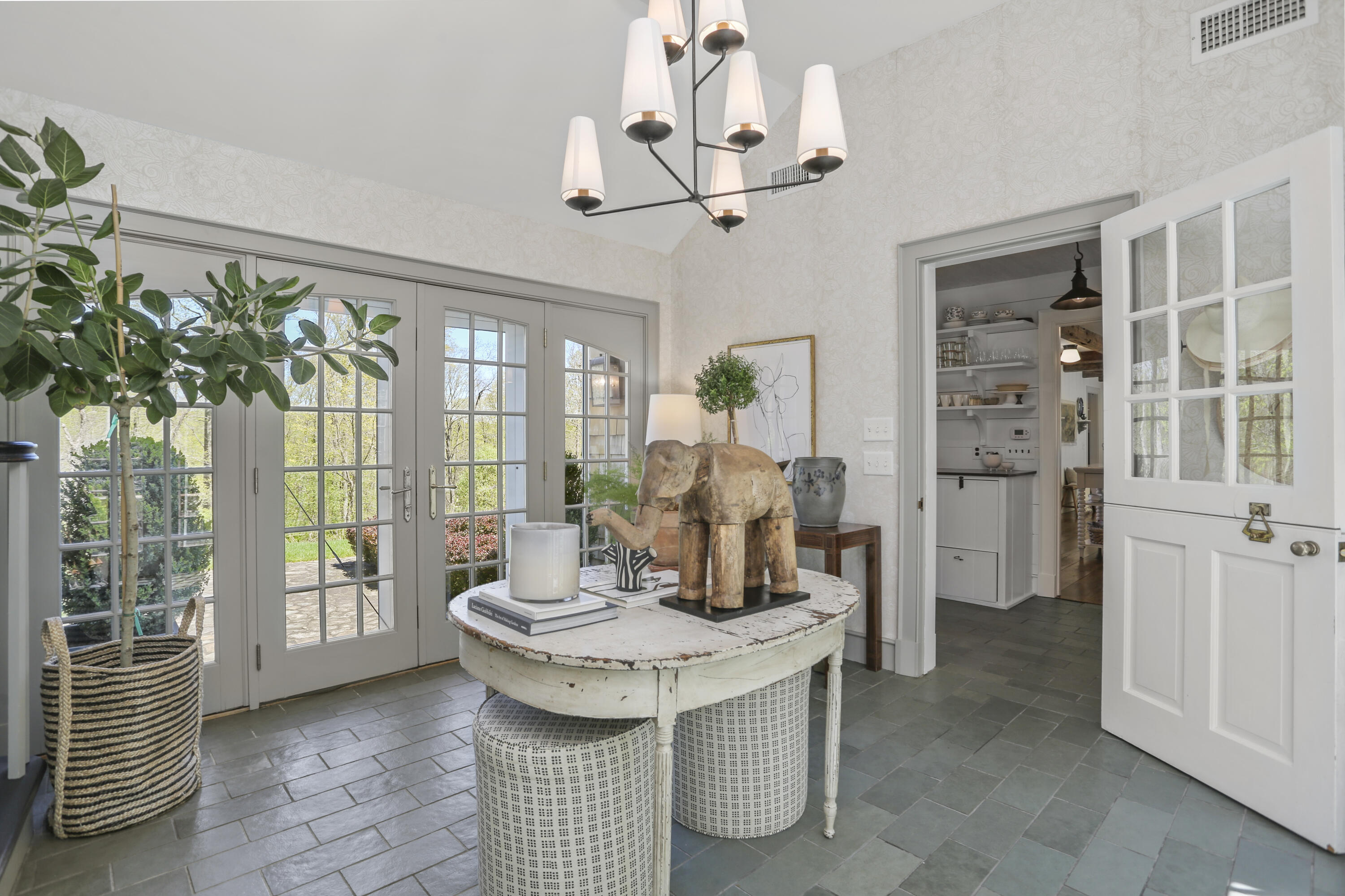 215 Cross Ridge Road New Canaan, CT 06840 - Photo 3 of 50 a dining room with furniture a chandelier and wooden floor