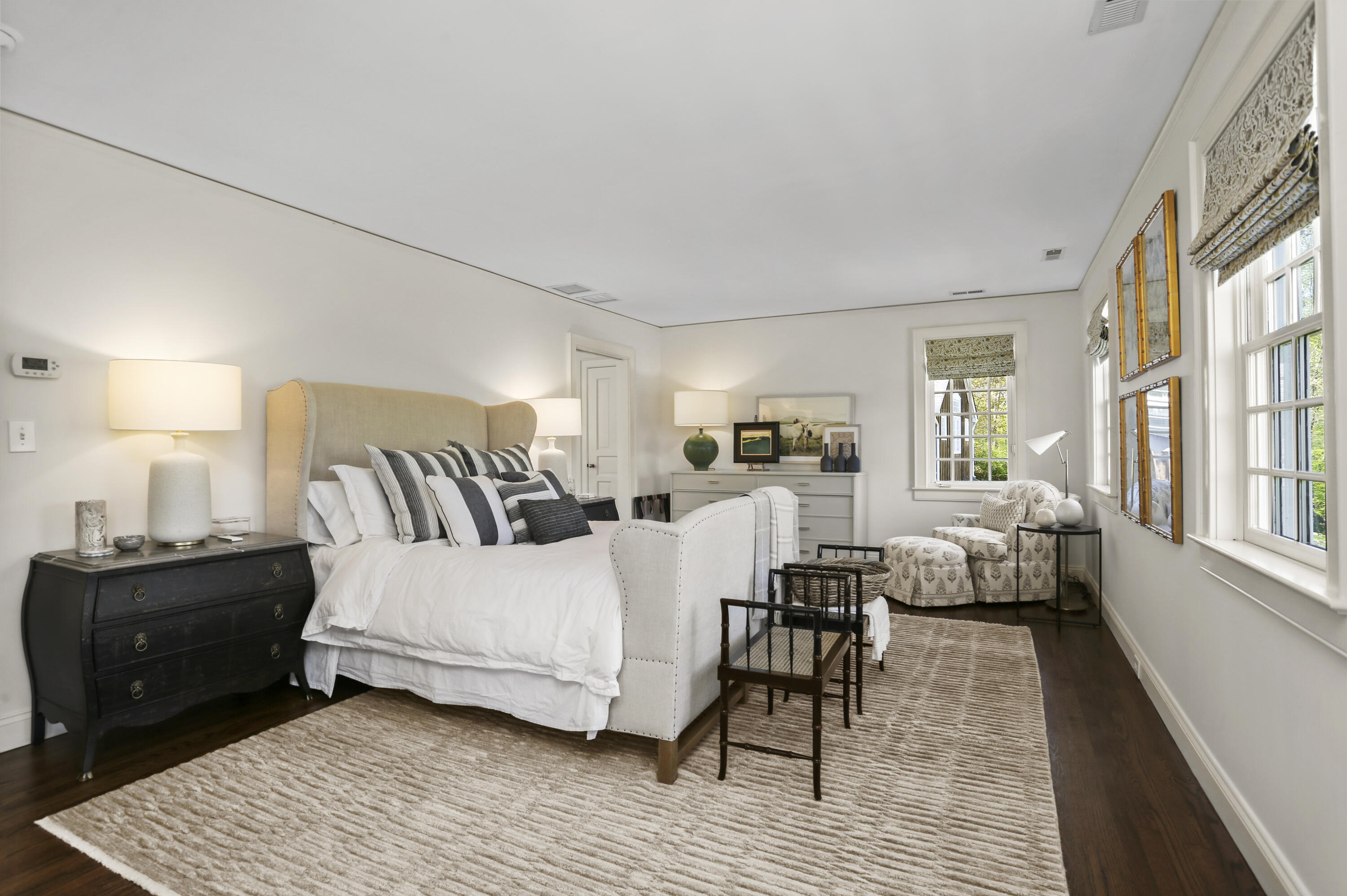 215 Cross Ridge Road New Canaan, CT 06840 - Photo 34 of 50 a spacious bedroom with a bed a table and wooden floor