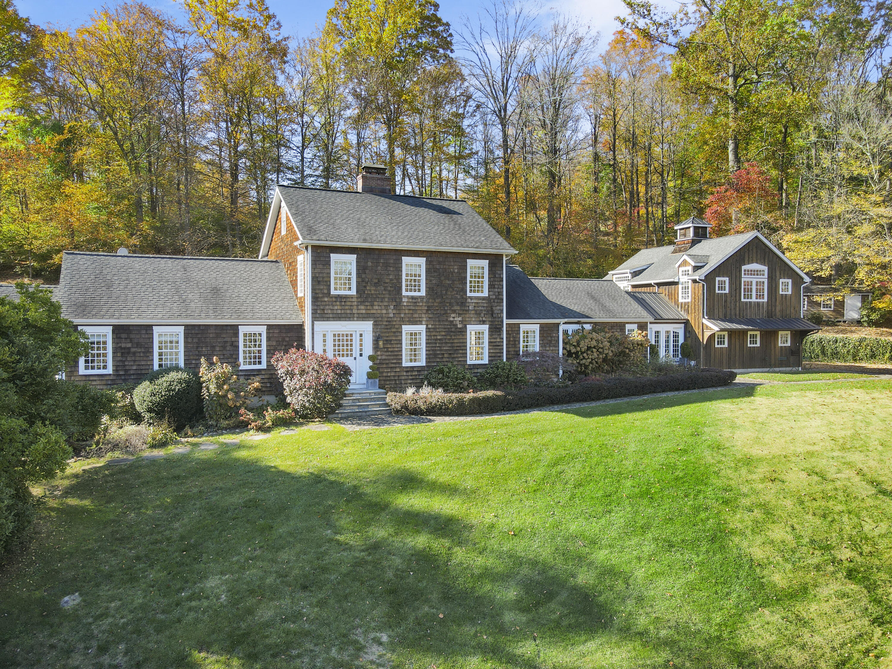 215 Cross Ridge Road New Canaan, CT 06840 - Photo 45 of 50 a front view of a house with yard and green space