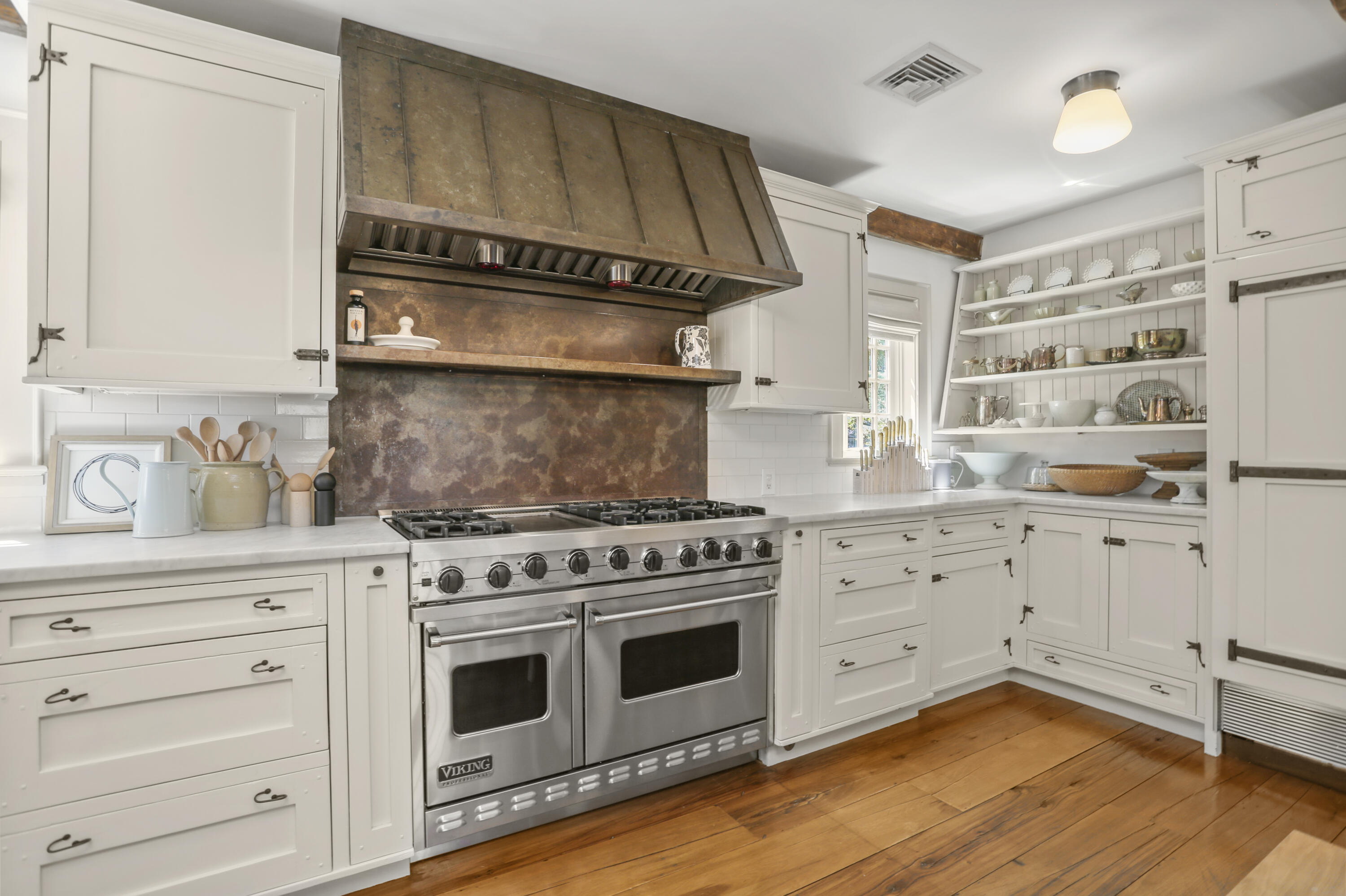 215 Cross Ridge Road New Canaan, CT 06840 - Photo 9 of 50 a kitchen with stainless steel appliances a stove and white cabinets