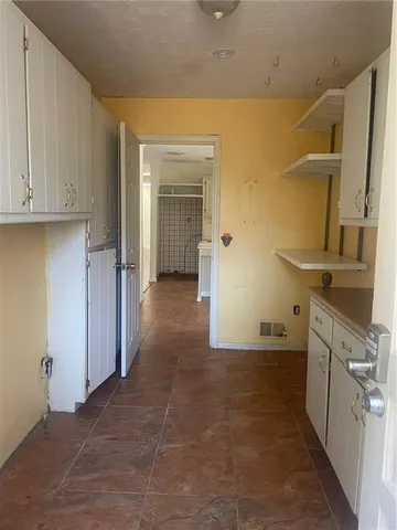 a view of a kitchen from the hallway