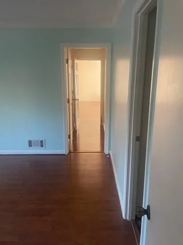 a view of a room with an empty space and a window