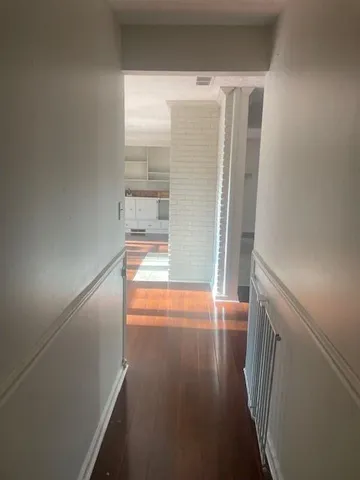 a view of hallway with wooden floor