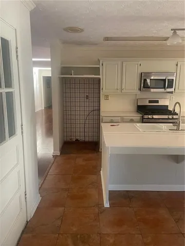 a kitchen with stainless steel appliances a refrigerator and cabinets