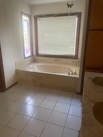 a spacious bathroom with a bathtub and a shower