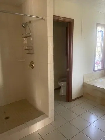 a bathroom with a bath tub and shower