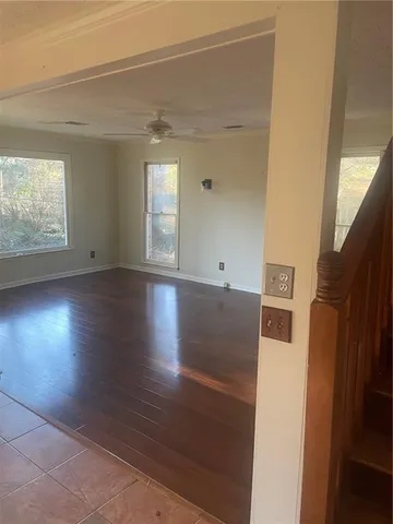 a view of a livingroom with wooden floor and window