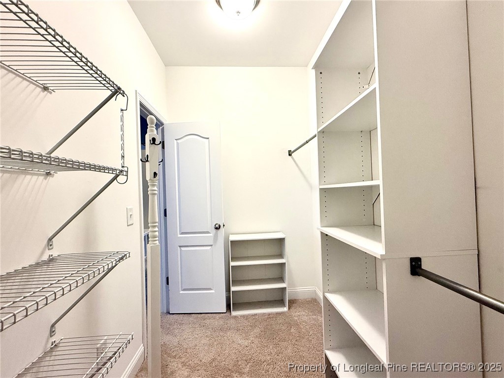 107 Judiciary Court Cameron, NC 28326 - Photo 16 of 49 a view of walk in closet with empty racks