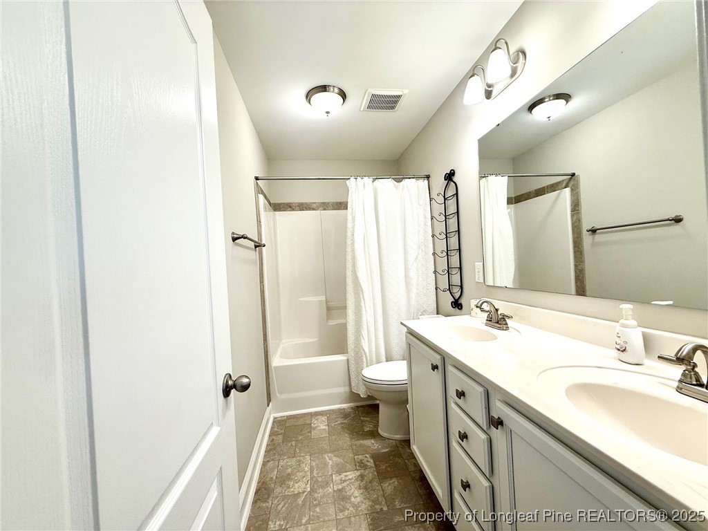 107 Judiciary Court Cameron, NC 28326 - Photo 31 of 49 a spacious bathroom with a double vanity sink toilet mirror and double
