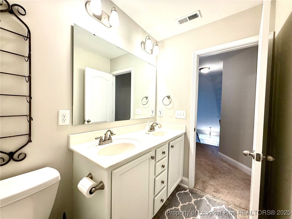 107 Judiciary Court Cameron, NC 28326 - Photo 32 of 49 a bathroom with a sink and a mirror