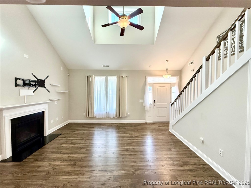 107 Judiciary Court Cameron, NC 28326 - Photo 4 of 49 a view of an empty room with wooden floor fireplace and a window