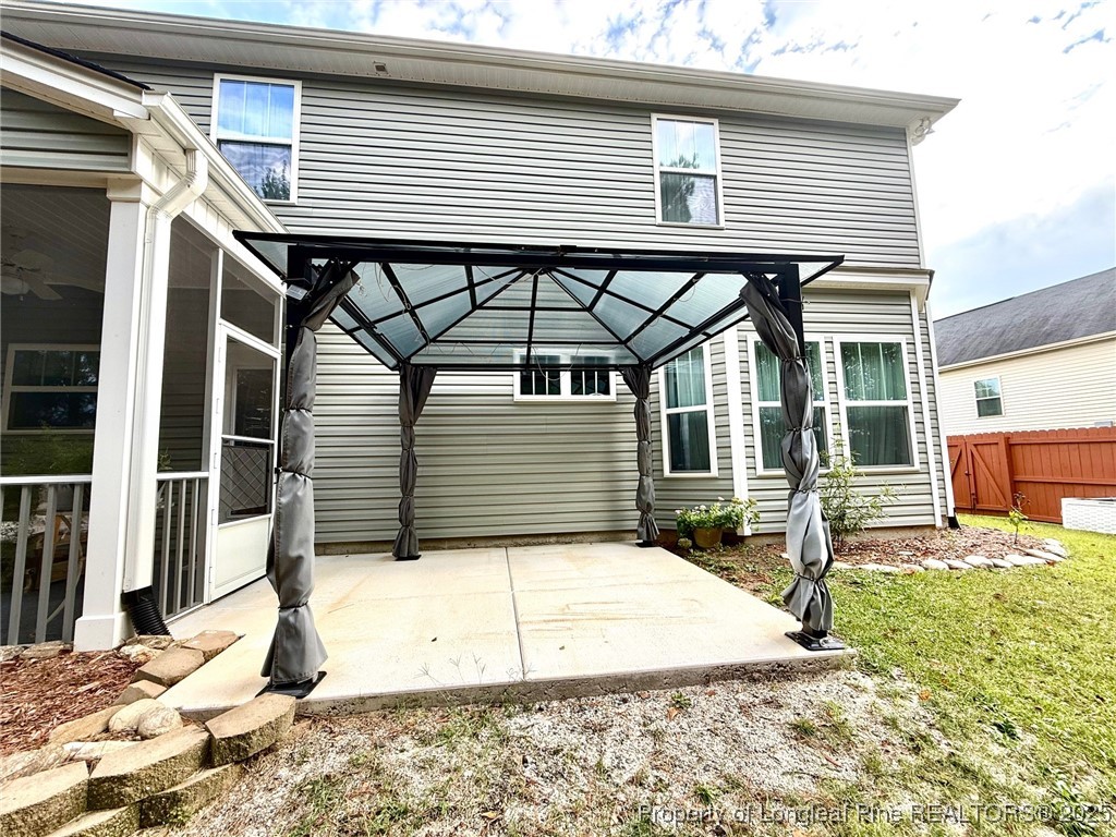 107 Judiciary Court Cameron, NC 28326 - Photo 41 of 49 a view of a house with a patio and wooden fence