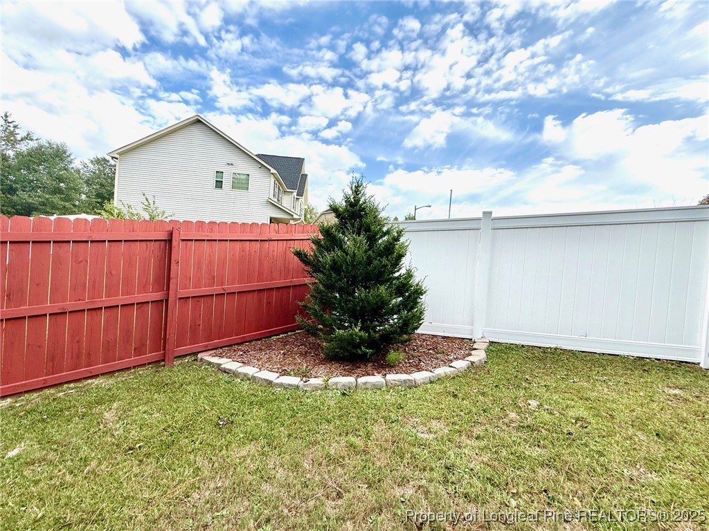 107 Judiciary Court Cameron, NC 28326 - Photo 45 of 49 a view of backyard with potted plants and wooden fence