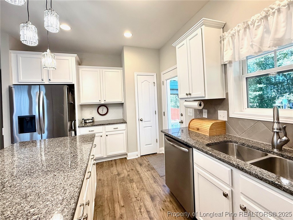 107 Judiciary Court Cameron, NC 28326 - Photo 9 of 49 a kitchen with stainless steel appliances granite countertop a sink refrigerator and cabinets