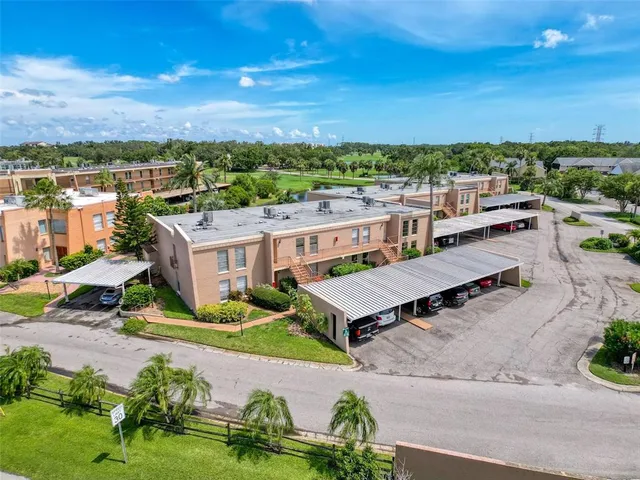 an aerial view of a house with a garden and lake view