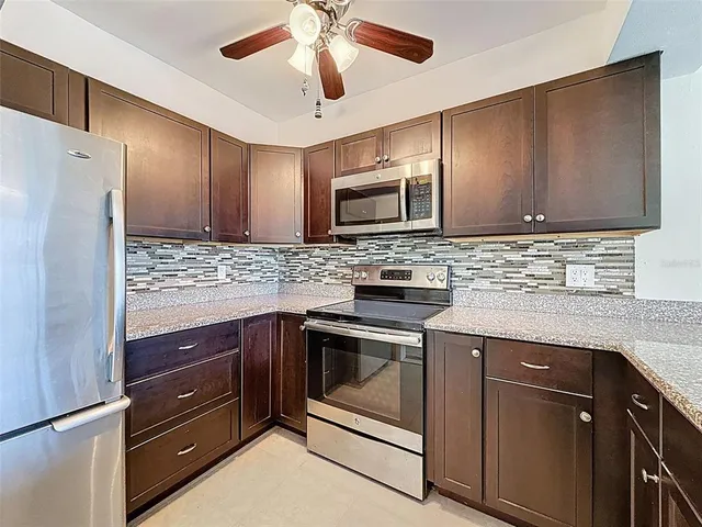a kitchen with a sink stove and microwave