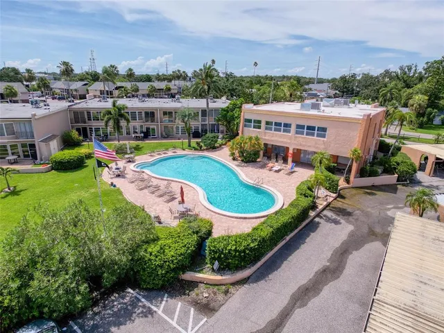 an aerial view of a house with a garden and lake view
