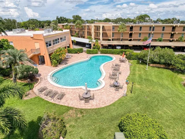an aerial view of a house with outdoor space and swimming pool