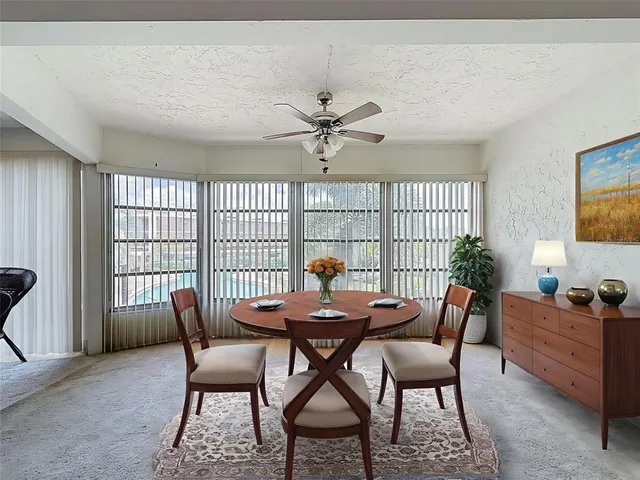 a dining room with furniture and window