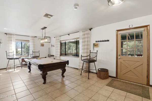 a view of a workspace with furniture and a potted plant