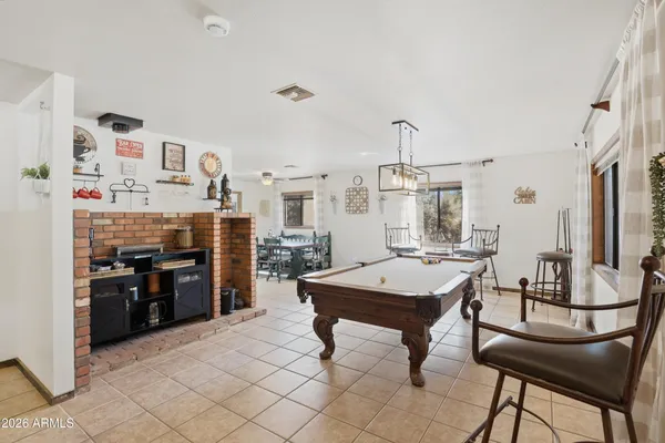 a room with furniture a rug and kitchen view