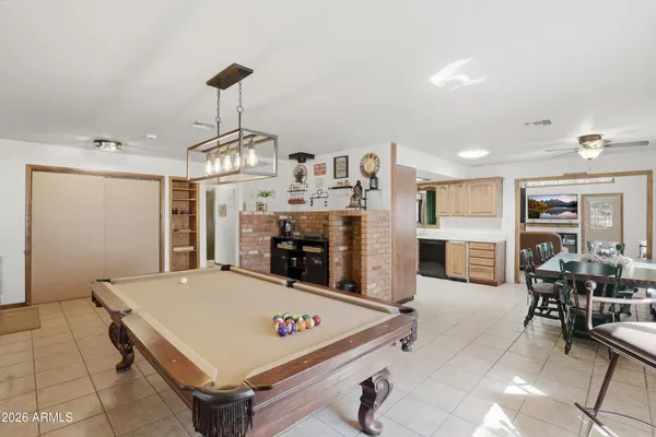 a room with furniture and pool table