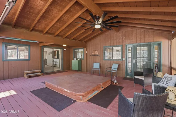 a living room with furniture a ceiling fan and a rug