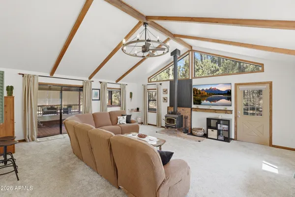 a living room with furniture a fireplace and gym equipment