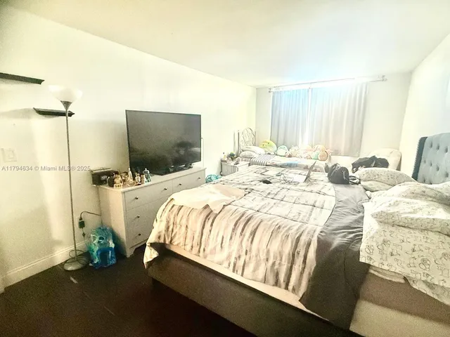 a bedroom with a bed and a mirror