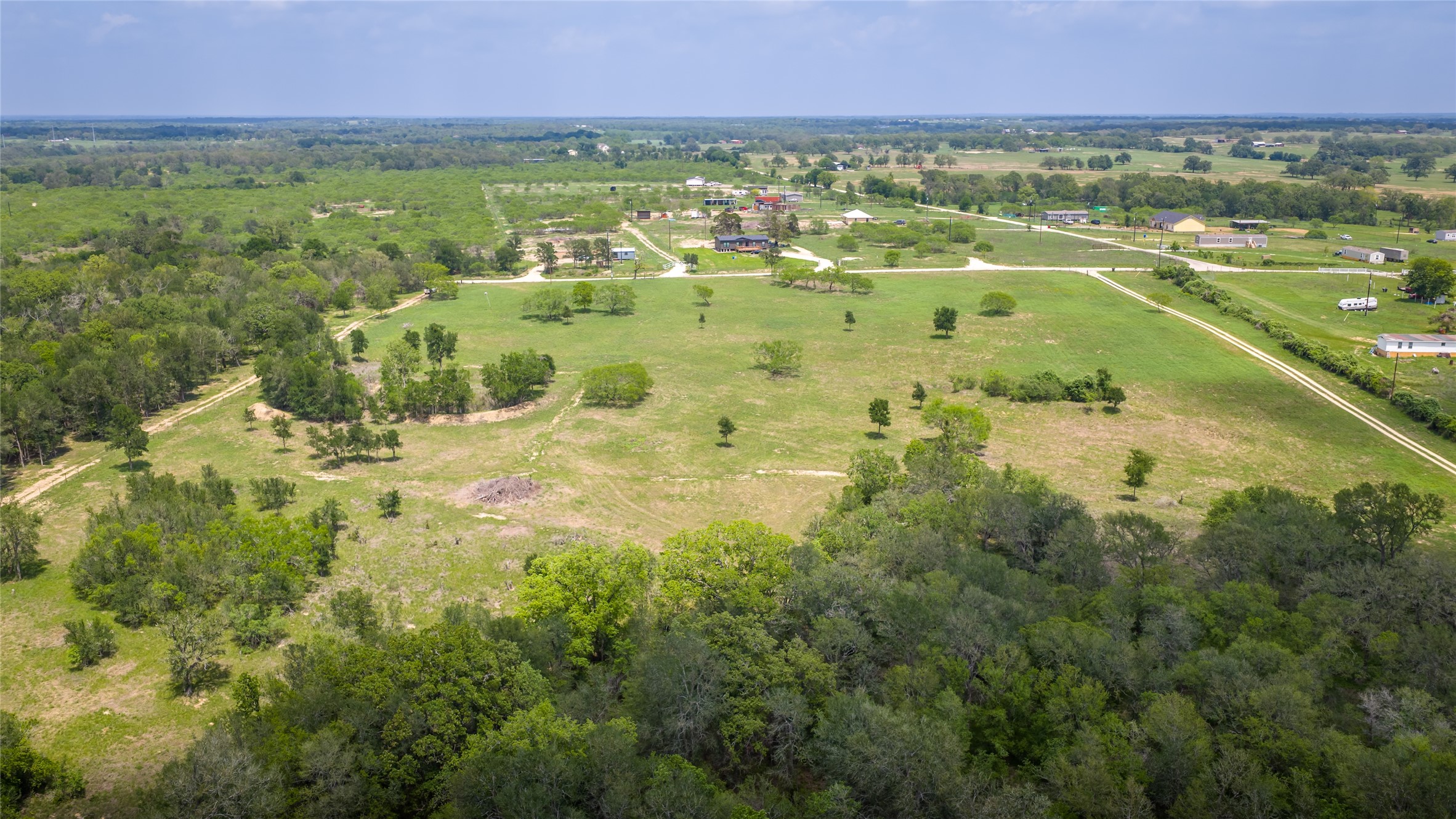 4082 Old Colony Line Road Lockhart, TX 78644 - Photo 28 of 40 Sprawling natural landscape with a blend of open fields and lush tree lines, ideal for a private estate.