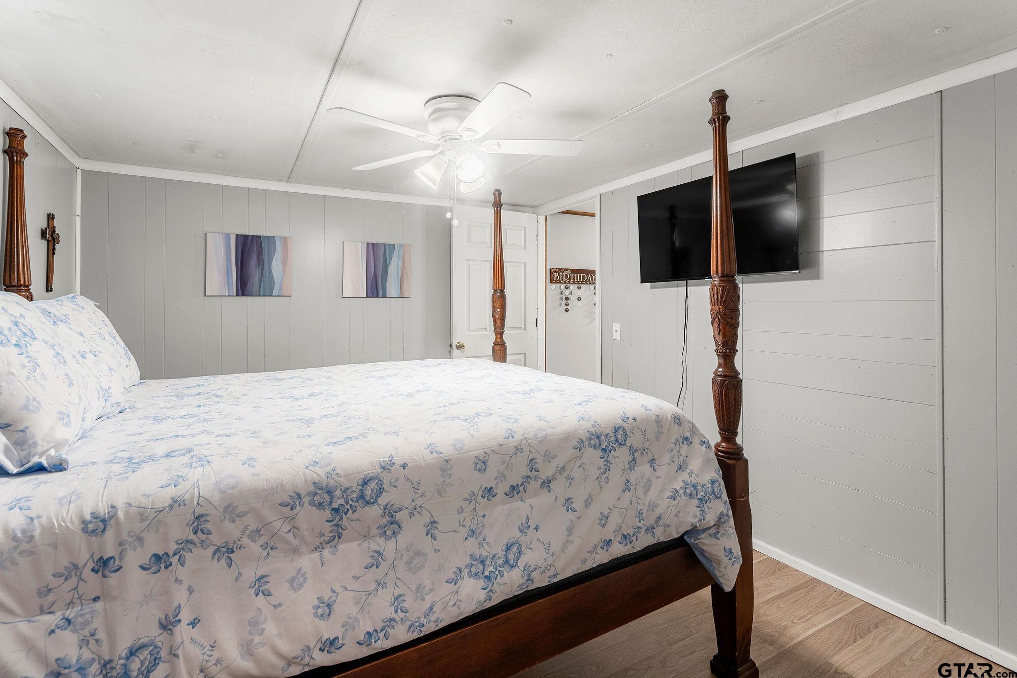 4550 Crabapple Road Gilmer, TX 75645 - Photo 18 of 33 a bedroom with a bed and a flat screen tv